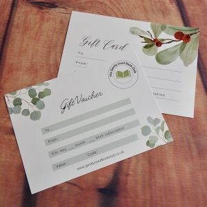 A choice of two gift voucher designs, one green and one red & green, against a wooden background