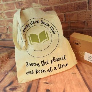 A cotton tote bag with The Gently Used Book C lub logo and our slogan "Saving the Planet One Book at a Time"